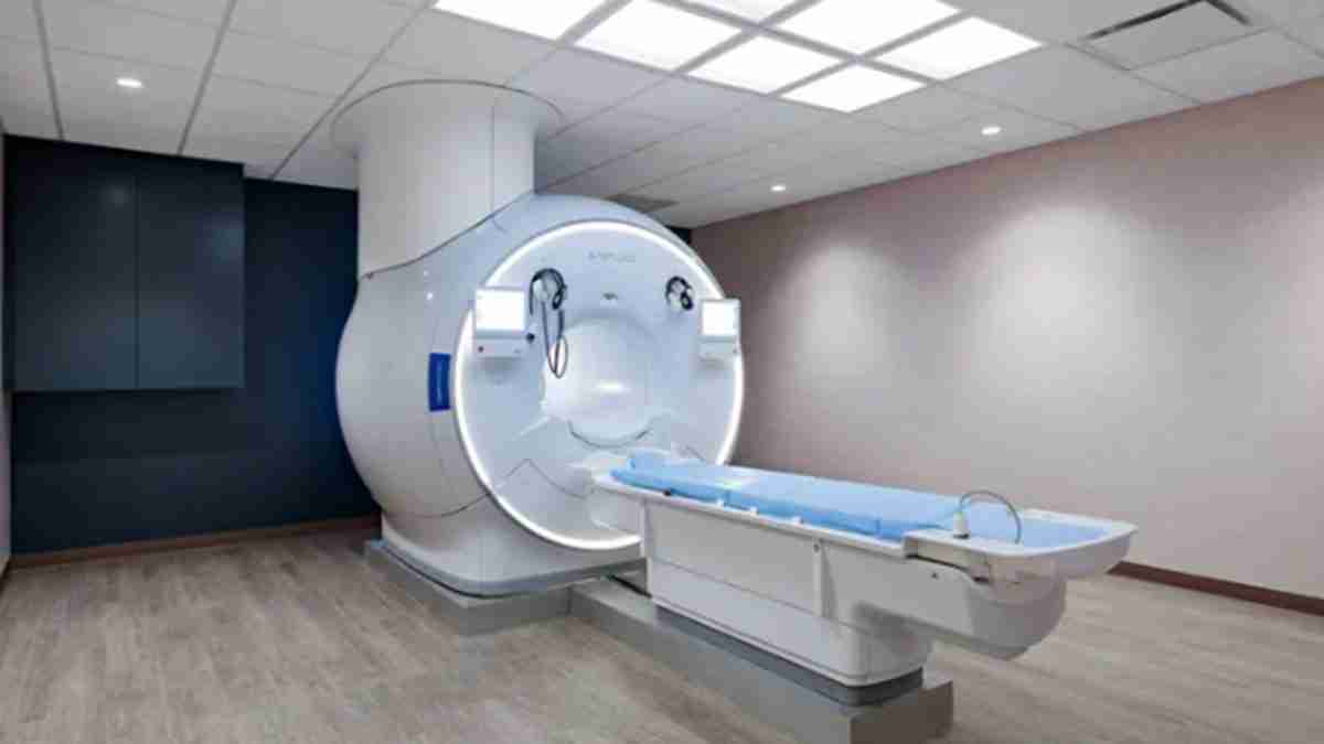 MRI machine in a clinical room with a sliding patient table ready for scanning.10