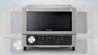Panasonic stainless steel microwave oven with a black windowed door and bottom control panel.
