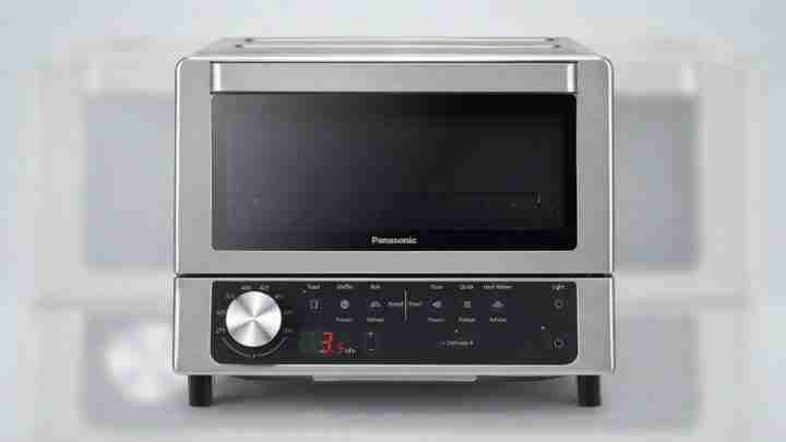 Panasonic stainless steel microwave oven with a black windowed door and bottom control panel.