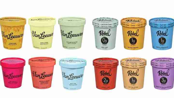 Row of Van Leeuwen ice cream cups in various colors with flavor names on the lids, arranged in two rows on a white background, vivid pastel tones on each container.
