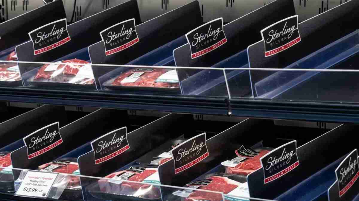 Cold meat display with multiple Sterling Silver Premium Meats packages in a refrigerated case.