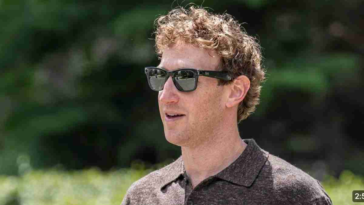 Man wearing dark sunglasses outdoors, facing slightly to the right with a neutral expression.